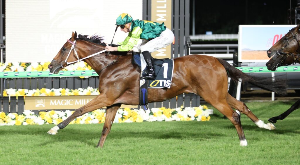 Jockey in green and yellow silks riding a bay horse at full gallop in a horse race, number 1 on the saddle cloth, colorful track backdrop.
