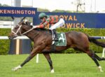 Jockey in green-and-red silks rides a galloping brown horse with saddle cloth number 4 at Kensington racecourse.