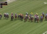 Pack of jockeys in bright silks riding Thoroughbreds on a green turf track at Royal Ascot; on-screen race clock and speed readout visible.