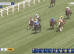 Live Royal Ascot turf race: group of jockeys in colorful silks ride horses along a straight green course by the rails.